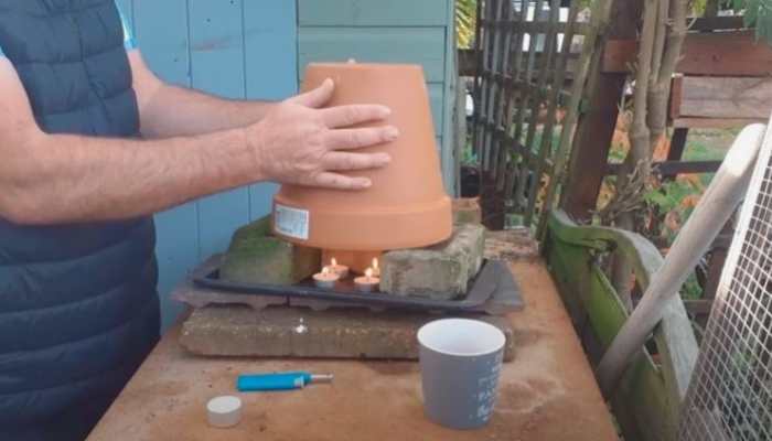 terracotta vase with candles for heating greenhouse